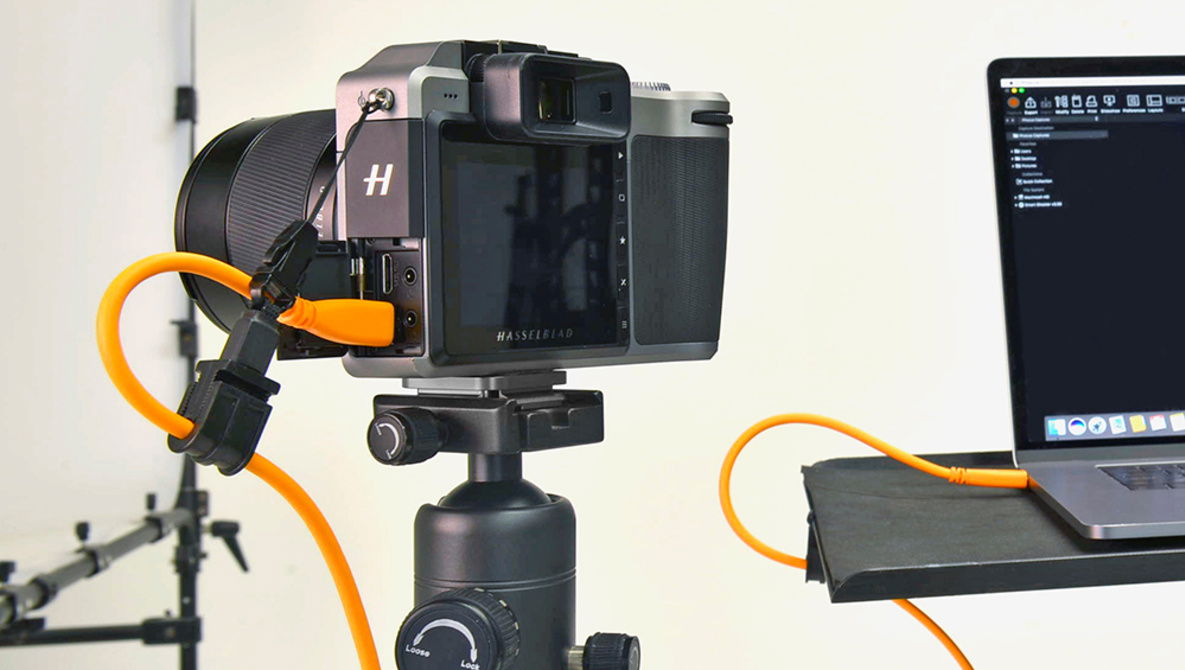 A DSLR camera tethered to a laptop - portable photo studio setup