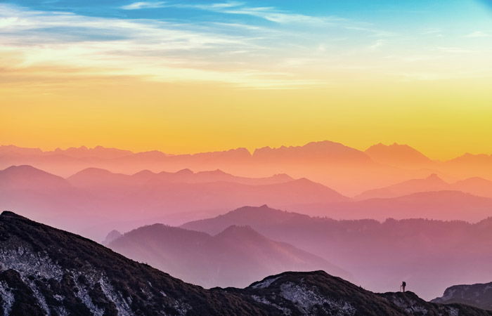 A mountainous landscape under a colorful sunset sky demonstrating colorful landscape photography