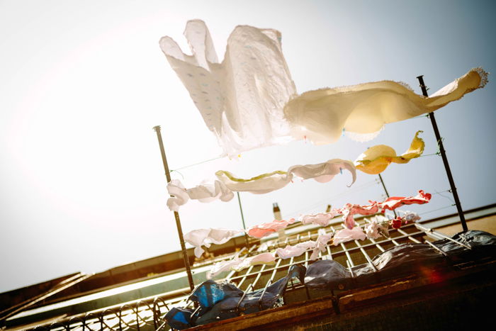 Laundry hanging outside a balcony shot from a low angle underneath