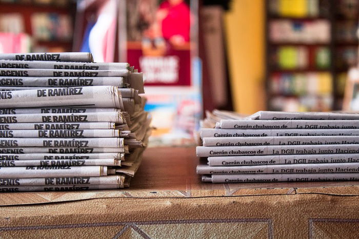 Two stacks of newspapers on a table