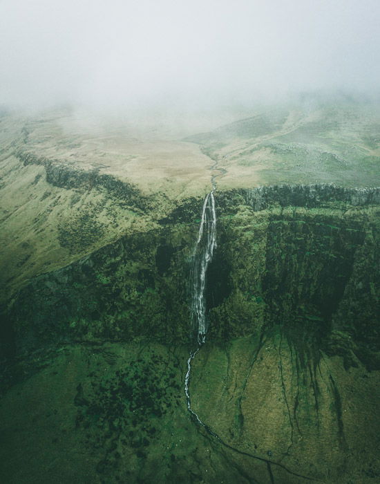 a birds eye view of a beautiful mountainous landscape with a waterfall - stunning landscape photos 