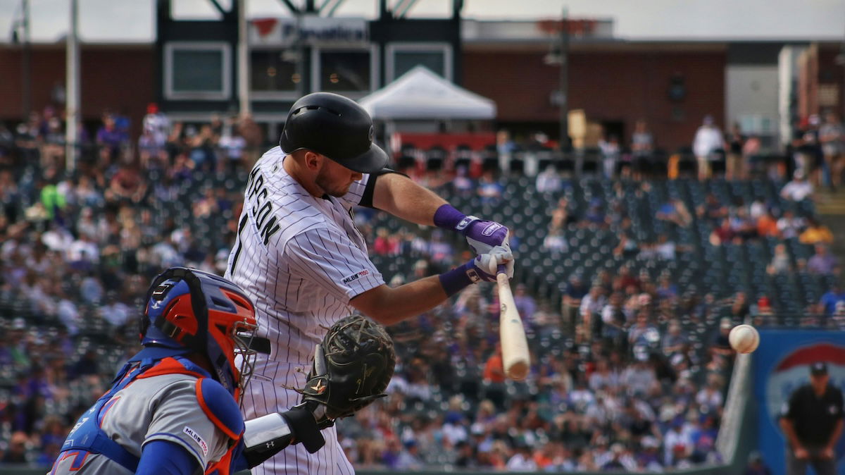 Close-up of a catcher and a batter about to hit the ball as an example for baseball photography