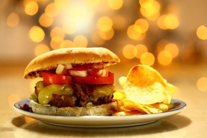 A delicious shot of a juicy burger and chips - camera flash photography