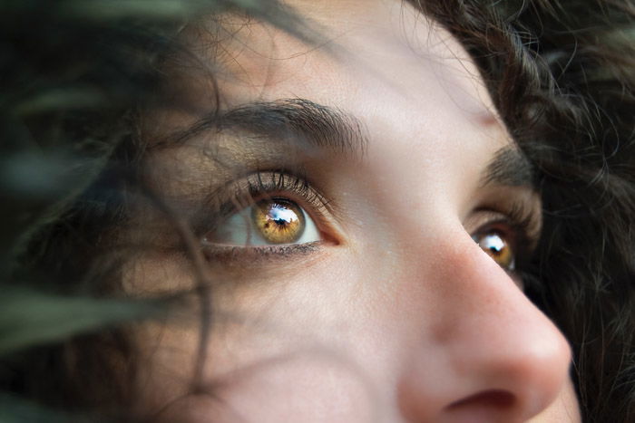 A stunning portrait of a female model featuring stunning light reflection in eyes