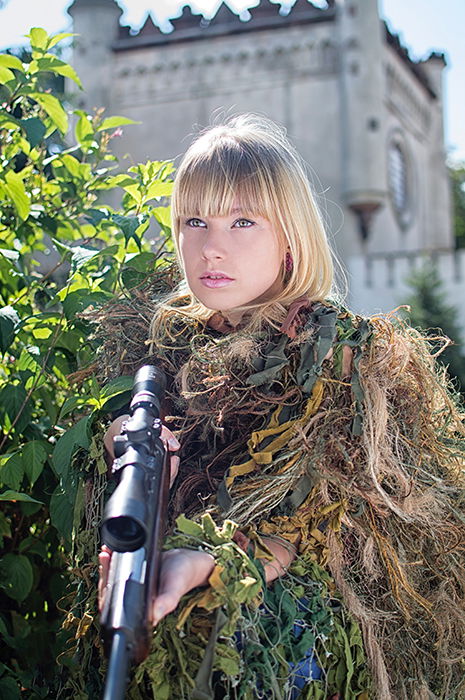 Dreamy cosplay photography of a female model dressed in army gear posing outdoors