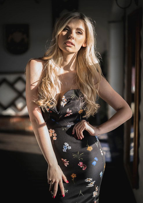 A female model posing indoors for a fashion lookbook shoot