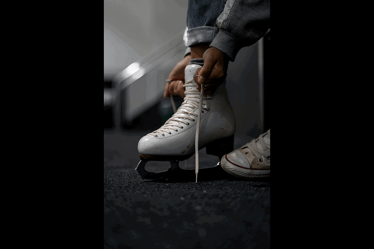 Close-up shot of a skater tying skates as an example of figure skating photography