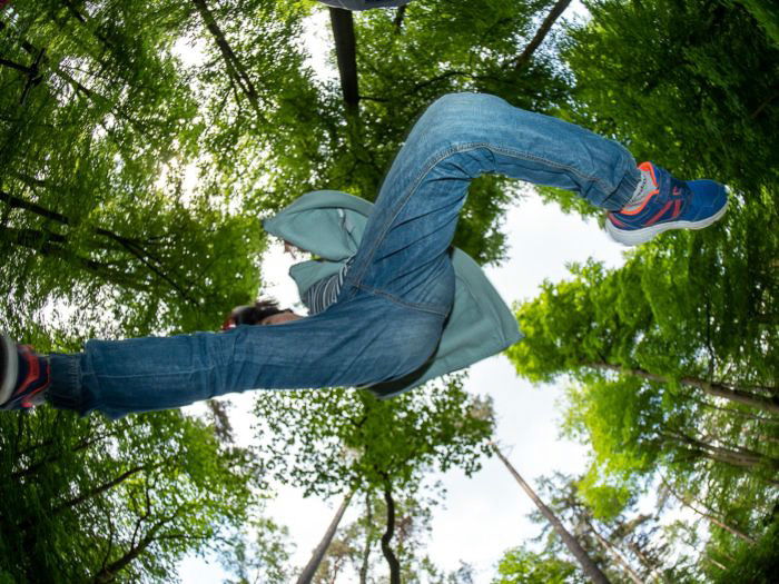 Cool fisheye photos of a child jumping in a forest