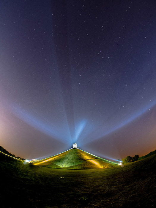 Atmospheric night photo of a building with concave horizon shot with a fisheye lens