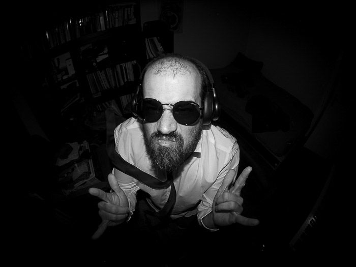 Overhead black and white fisheye portrait of a man in sunglasses