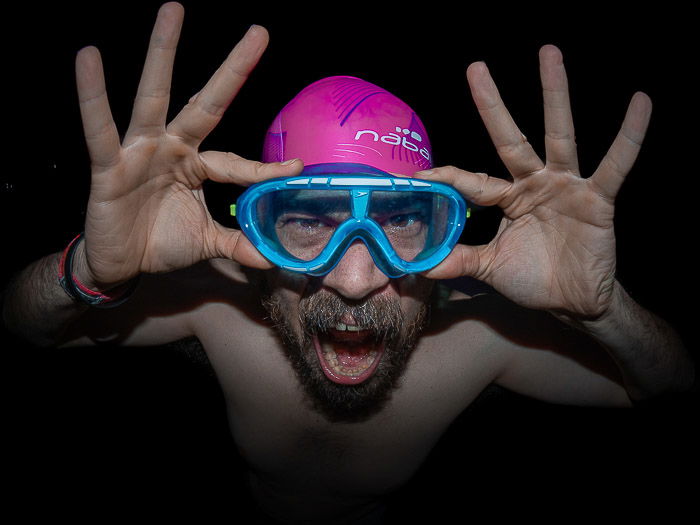 Humorous portrait of a man in swimming gear shot with a fisheye lens