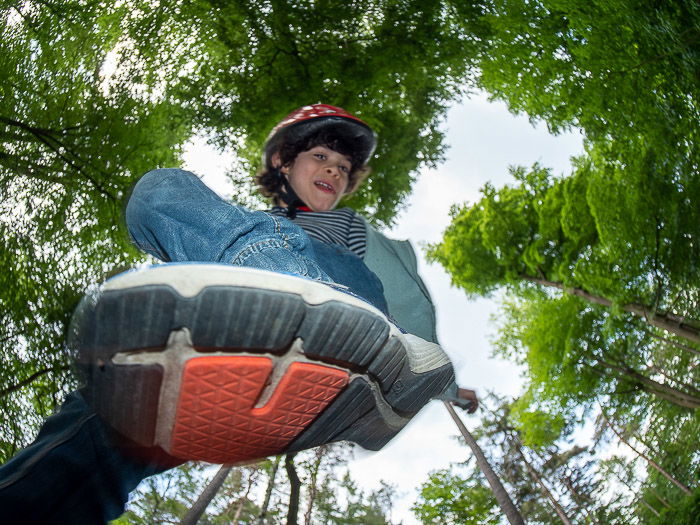 Cool fisheye photos of a child jumping in a forest