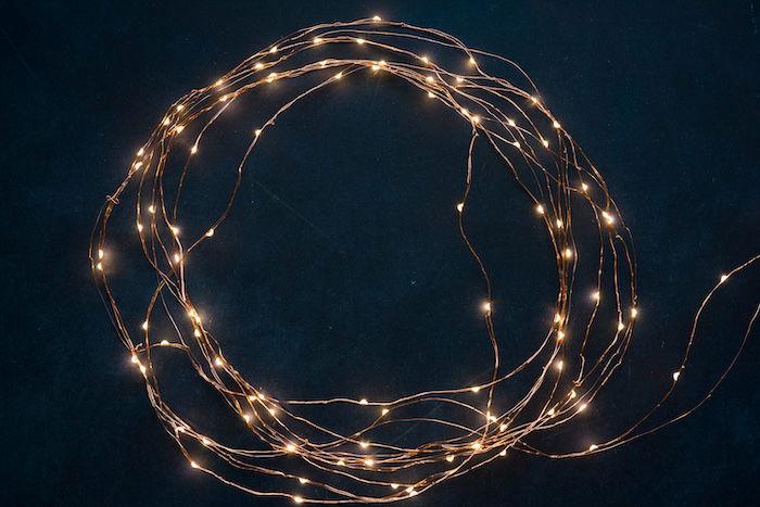 White fairy lights on a dark tabletop for heart bokeh photography