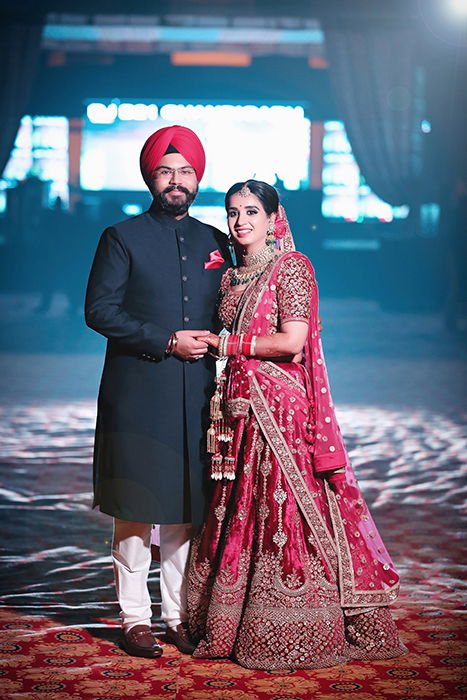 Beautiful wedding portrait of an Indian couple posing in traditional costume - Indian wedding photography