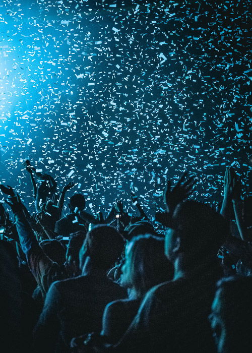 low light shot of confetti falling on the crowd at a fashion show