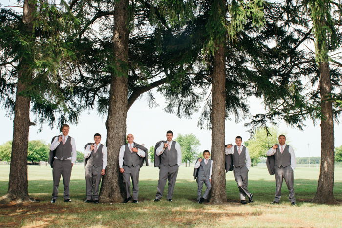  wedding portrait of the groomsmen posing between trees - wedding photography business tips