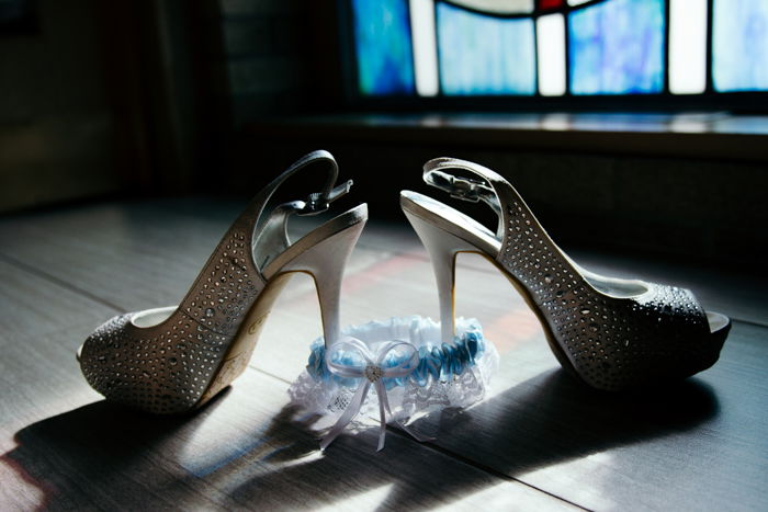 atmospheric still life of wedding shoes and garter on the floor - wedding photography business tips