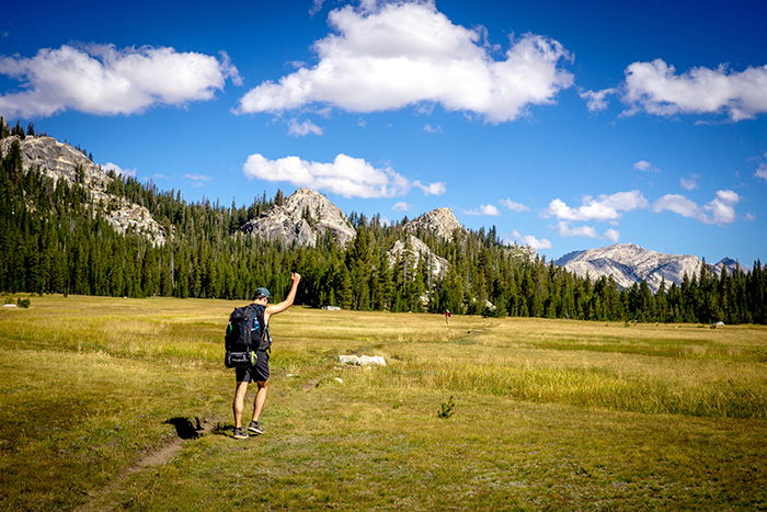 A hiker in Tuolumne Meadows, best photography spots for yosemite photos