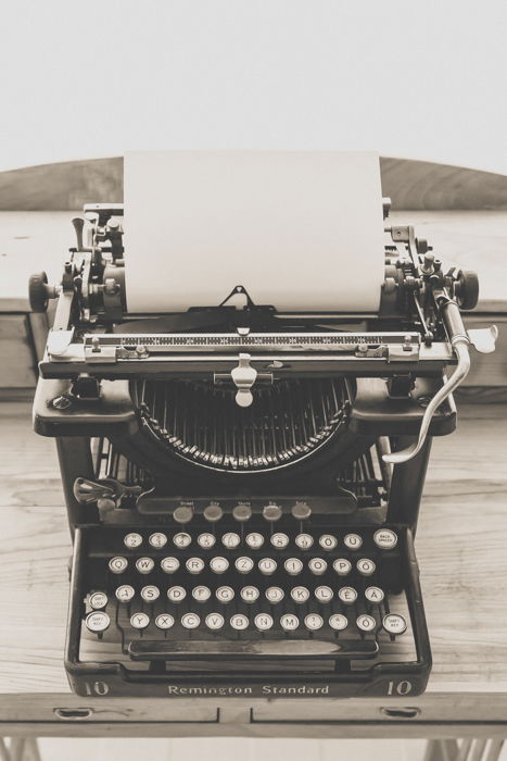 a black and white still life of an antiques typewriter - vintage photography tips