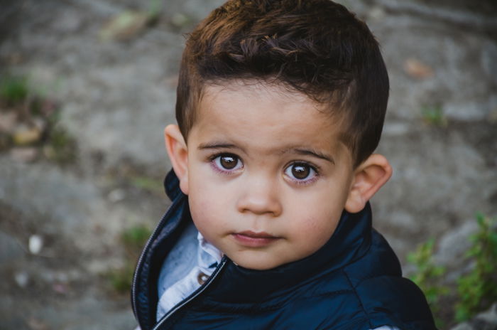 A portrait of a little boy looking up at the camera - Lightroom clarity tool