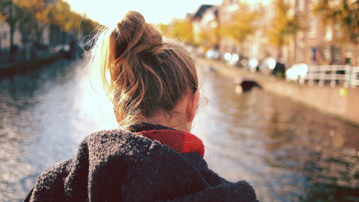 a portrait of a girl by a river