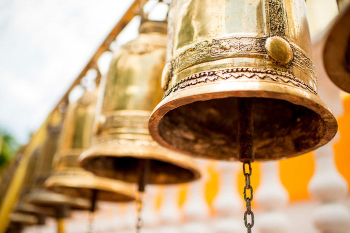 a row of golden bells shot at a dutch angle