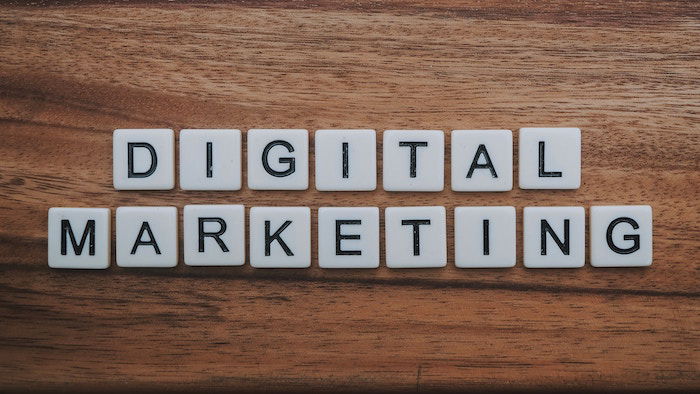 scrabble pieces spelling 'Digital Marketing' on a wooden table 