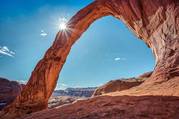 a starburst behind a rock formation