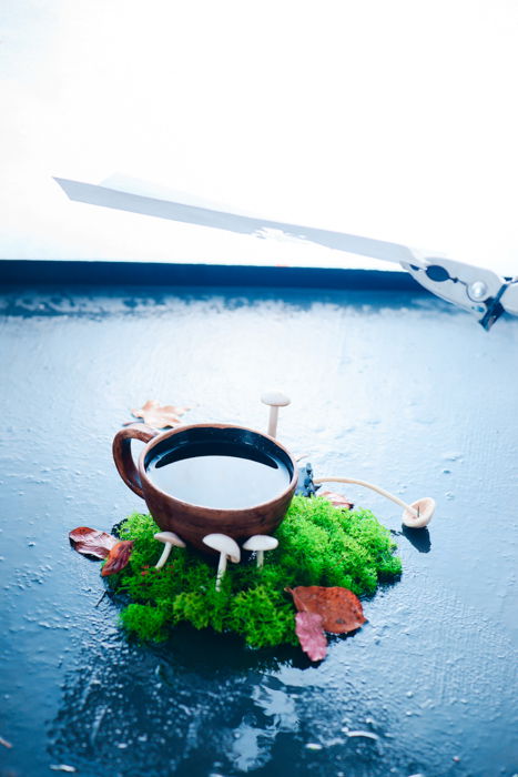 a creative still life featuring reflections in a coffee cup