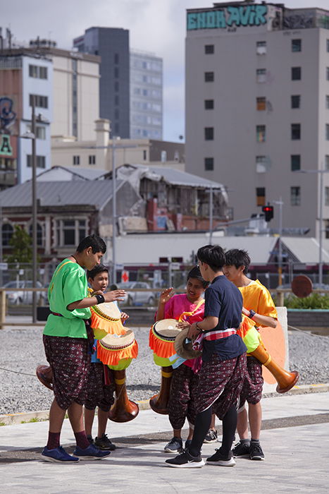 candid street photo of a group of children drumming outdoors