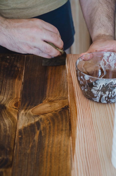 a person making a DIY wood backdrop for photography