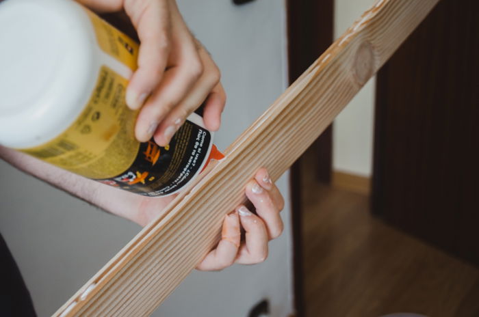 a person making a DIY wood backdrop for photography