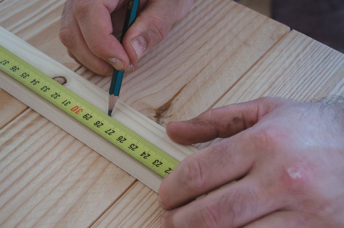 a person making a DIY wood backdrop for photography