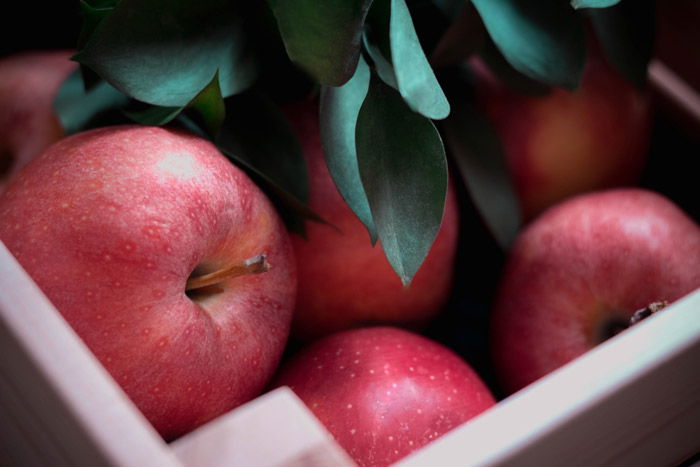 red apples in a box - symbolism in photography