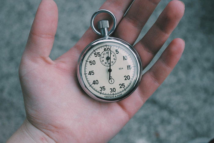 a pocket watch in a persons hand - symbolism in photography