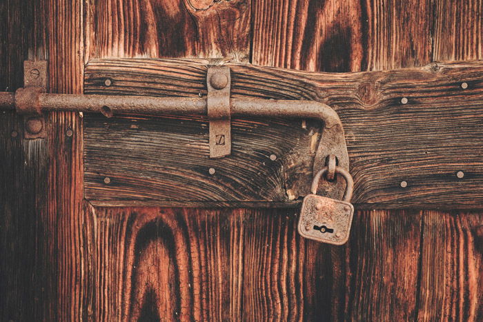 a padlock on a wooden door - symbolism in photography