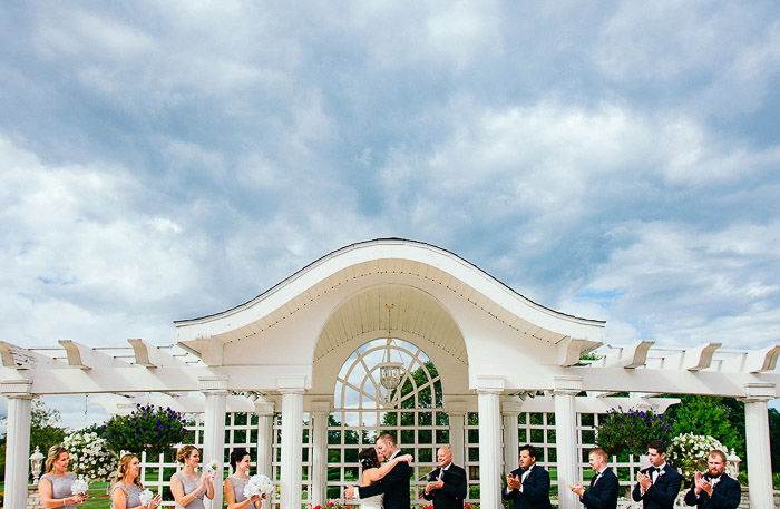 a group shot of the wedding party at an outdoor wedding photography shoot