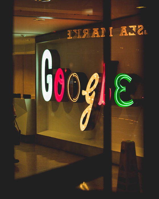 a neon google sign on a window