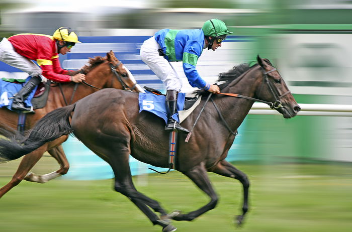 two jockeys on horses during a race