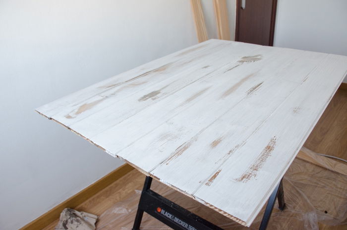 a person making a DIY wood backdrop for photography