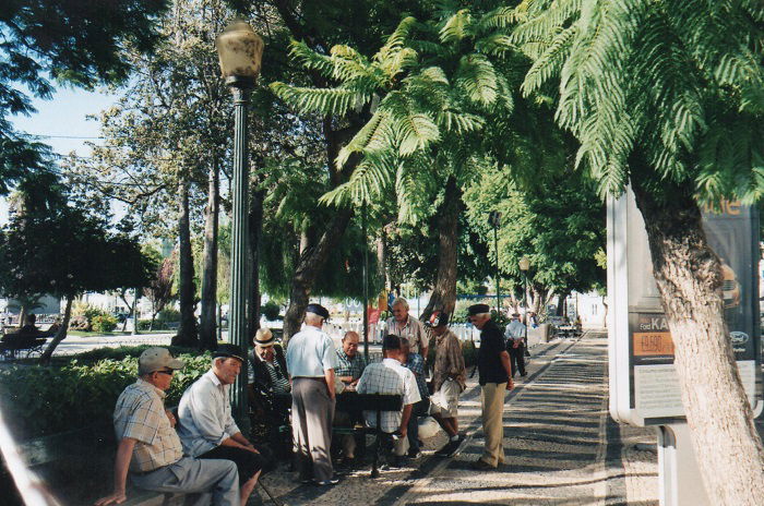 Group of old fellas playing a board game in a public park