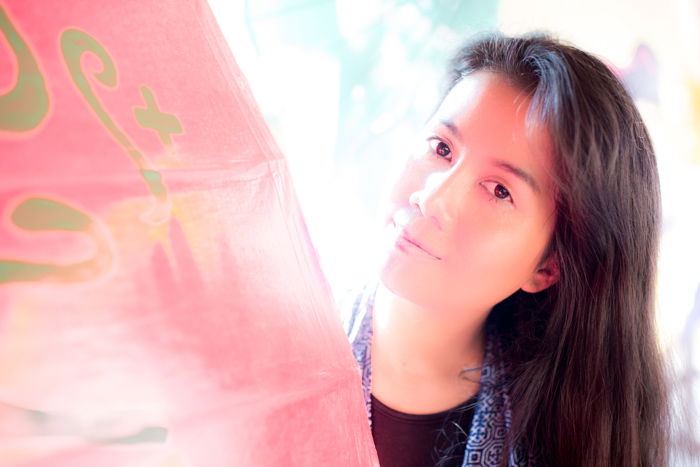 Outdoor portrait of a female model with reflected light on the models face from an umbrella