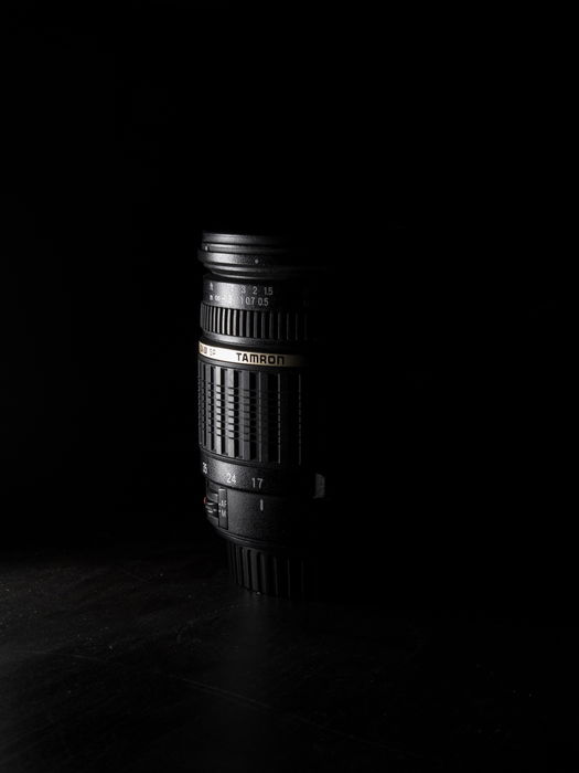 Shadowy photo of a Tamron lens highlighting Tamron lens abbreviations 