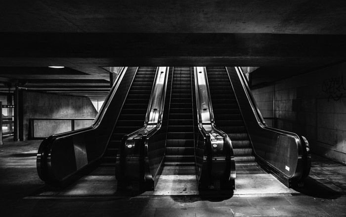 Black and white photo of escalators