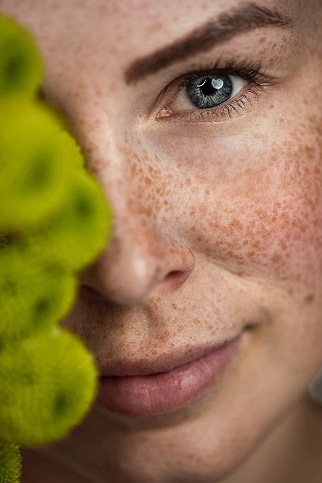 Close-up portrait photography of a woman with freckles