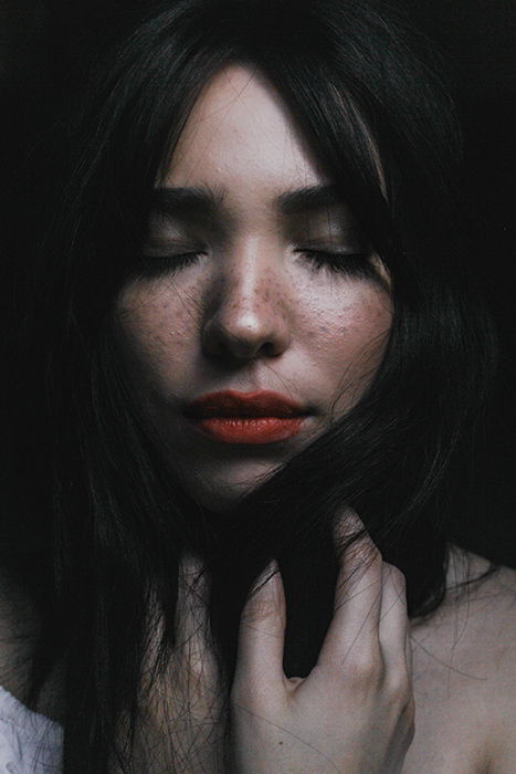 Close up portrait of a woman with dark background