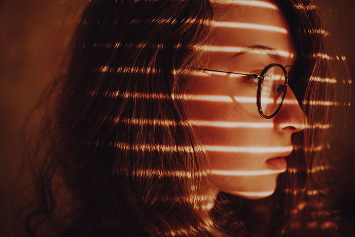 Close-up portrait of a woman with a lighting pattern on her face