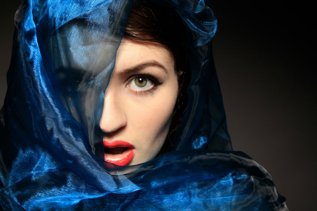 A woman with her face partially covered by a veil as an example of framing photography shots