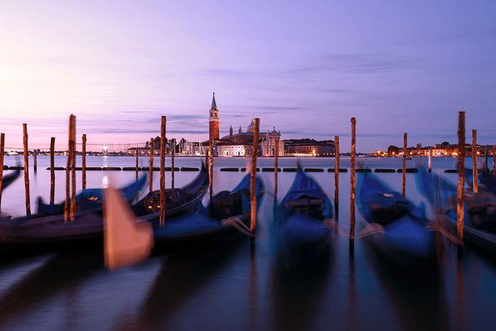 Photo of gondolas in Venice at sunset