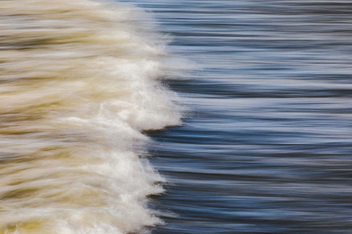 Blurry ocean waves created by handheld panning for intentional camera movement